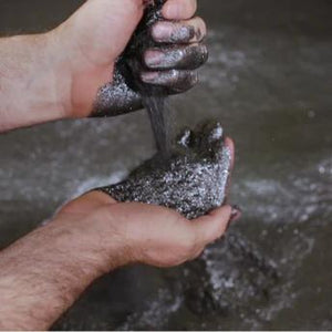 hands pouring graphite